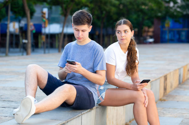 istock Two teenagers chatting on their smartphone 1353649951