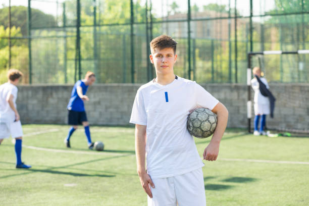 istock Junior football player on field 1353650729