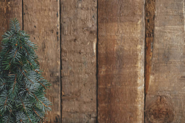 istock Stylish christmas tree on rustic  background. Space for text. Season's greeting. Handmade fir tree 1353653779