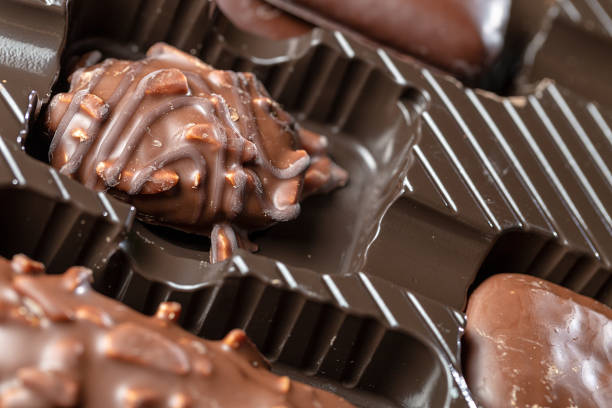 istock Appetizing food background. Assorted handmade candy in the box close up. Chocolate background. 1353654120