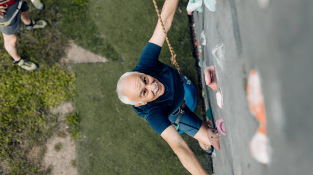 istock Senior man climbing on the artificial rock 1353655267