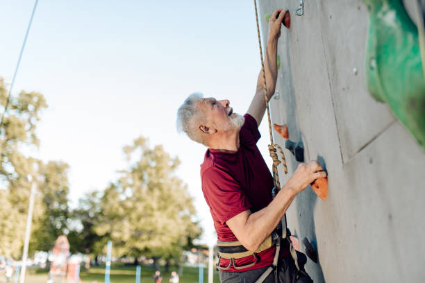 istock Senior man climbing on the sport climbing wall 1353655549