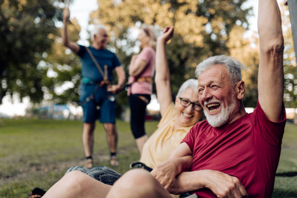 istock Senior couple trying climbing on the artificial rock 1353655586