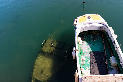 Sunken fisher boat in the harbour of Bari
