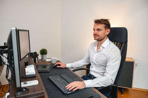 Businessman using a desktop PC to work on a project