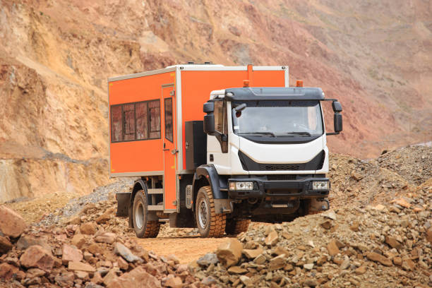 istock A special vehicle for transporting technical personnel in a quarry for the extraction of minerals. Bus for transportation of people in the quarry 1353658587