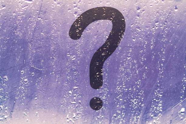 istock question mark on a wet window glass 1353659696