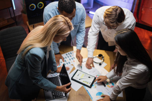 istock Multiracial business partners analysing graphs at office 1353660196