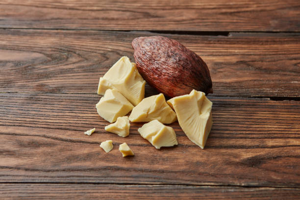 Whole cocoa pod with solid butter stock photo