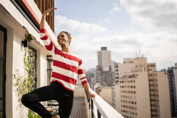 istock Male ballet dancer practicing in the apartment's balcony 1353661560
