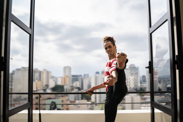 istock Male ballet dancer practicing in the apartment's balcony 1353661573