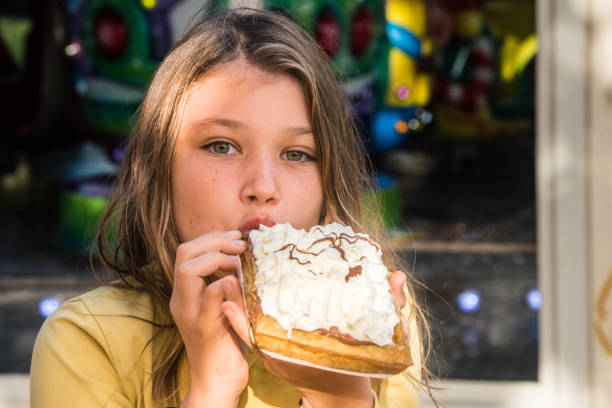 istock cute little girl enjoying a waffle 1353662729