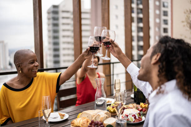istock Friends celebrating and toasting during lunch on a rooftop 1353662832
