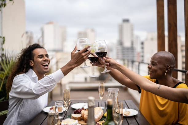 istock Friends celebrating and toasting during lunch on a rooftop 1353662917