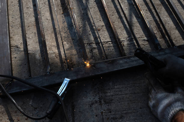 istock Iron gate repair, Worker hand welding steel 1353662939
