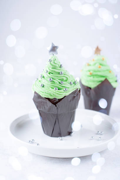 istock Christmas tree-shaped buttercream cupcake, festive muffin decor. 1353664261