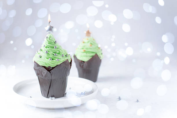 istock Festive muffin decor, Christmas tree-shaped buttercream cupcake. 1353664287
