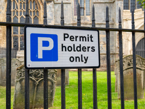 istock 'Permit Holders Only' sign outside a church graveyard 1353664485