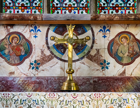 A gilt cross on the altar in St Mary’s Church in Old Hunstanton, Norfolk, Eastern England. The church dates to the 14th century and was built by order of Sir Hamon Le Strange, though there has been much restoration, especially in the 19th century.