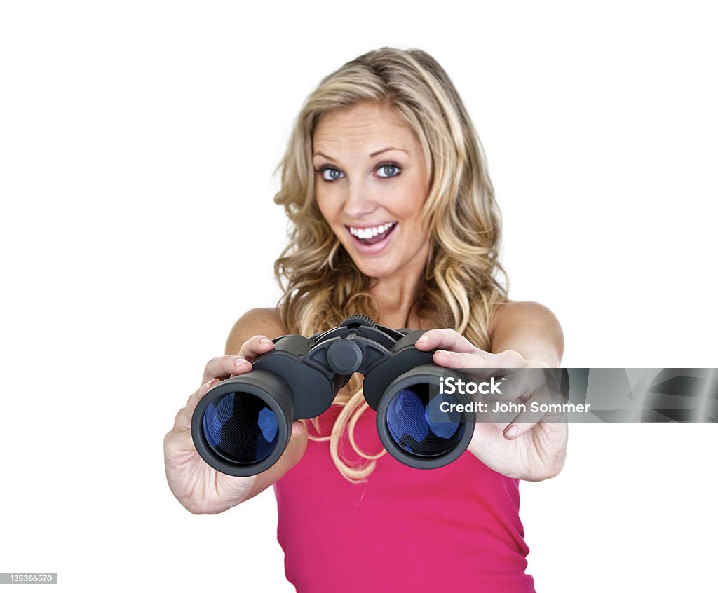 Happy woman holding out binoculars Woman with big smile holding out binoculars selective focus on foreground  Binoculars Stock Photo