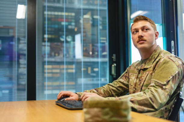 istock Professional Working Caucasian Male National Guard Officer in Office Setting Using Technology Photo Series 1353665951