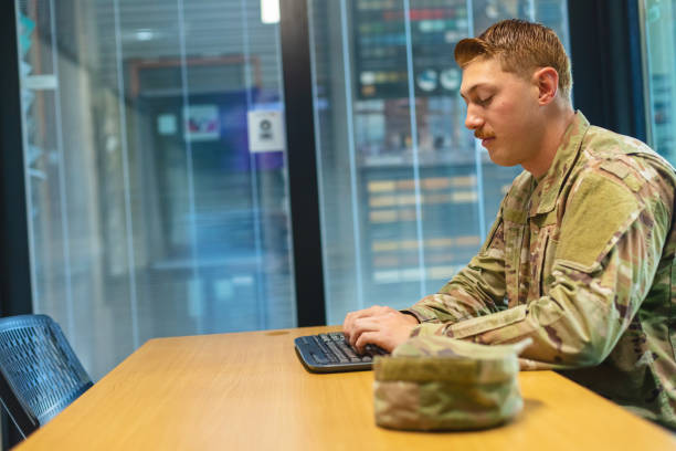 istock Professional Working Caucasian Male National Guard Officer in Office Setting Using Technology Photo Series 1353665988