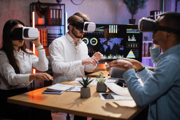 istock Group of diverse IT specialists using VR headset at office 1353666003