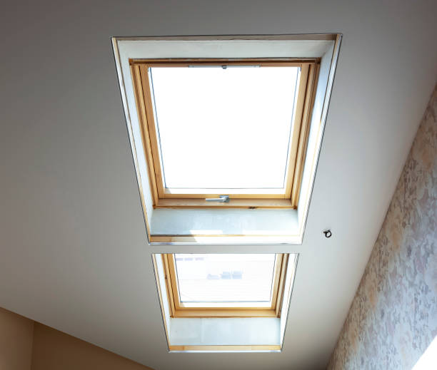 istock wooden dormer windows in the attic room with bright white light 1353666095