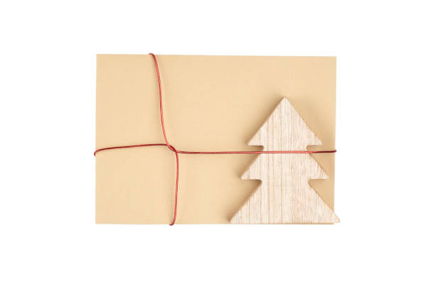 istock Blank brown envelope with wooden christmas tree on the white background,copy space 1353667880
