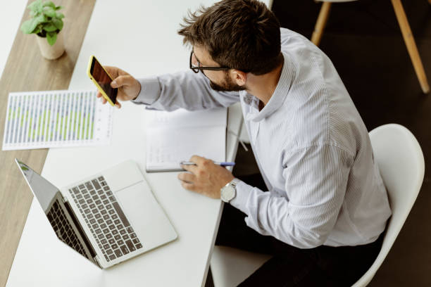 istock Businessman With Smartphone in the Office 1353668349