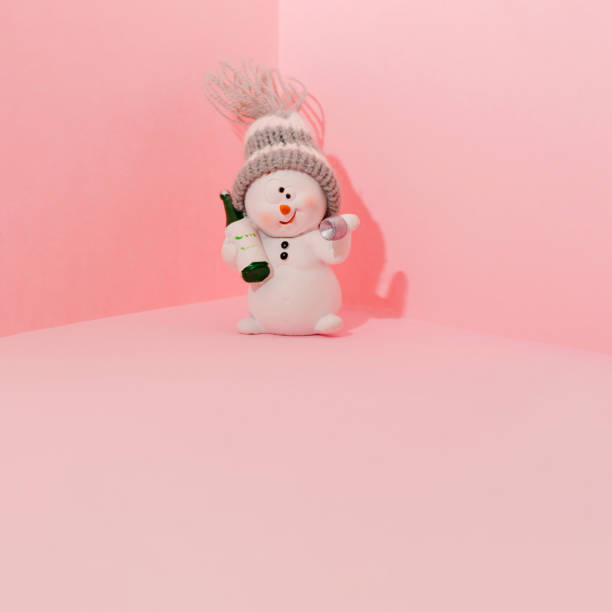 istock Drunk snowman against pink background. Winter holidays minimal concept. 1353669488