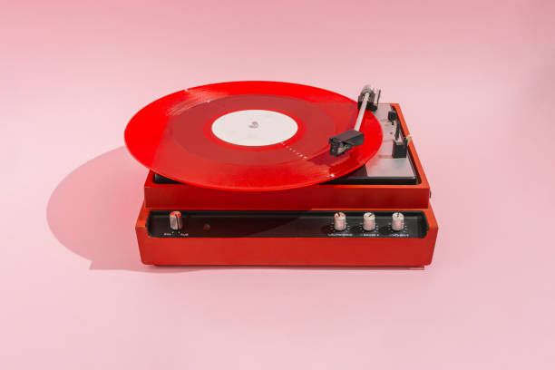 istock Red vinyl LP on red record player with light pink background. Minimal party concept. 1353669524