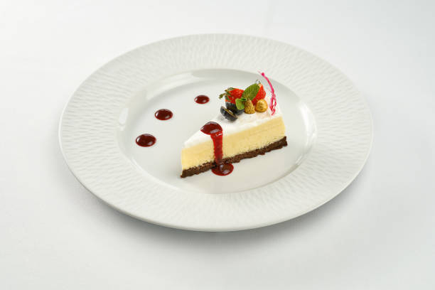 istock Cheesecake with sauce in a white plate on a white plate 1353670219