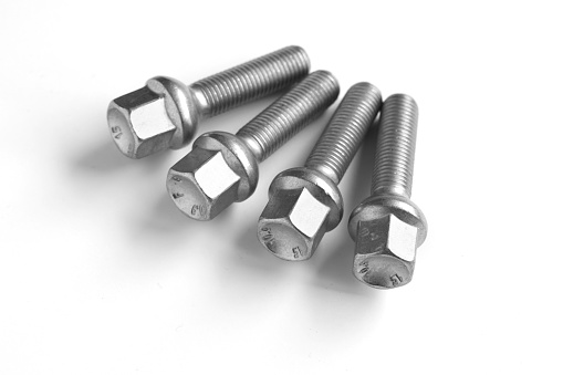 Top view of stainless steel screws and nuts isolated on white background with clipping path.