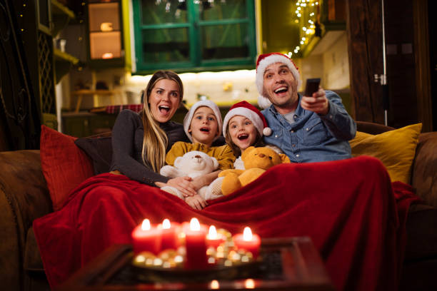Christmas isn't complete without a fun movie marathon Young family enjoying Christmas movies at home image type stock pictures, royalty-free photos & images