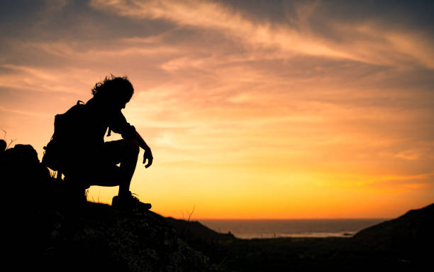 istock Male hiker enjoying beautiful sunset. 1353675989