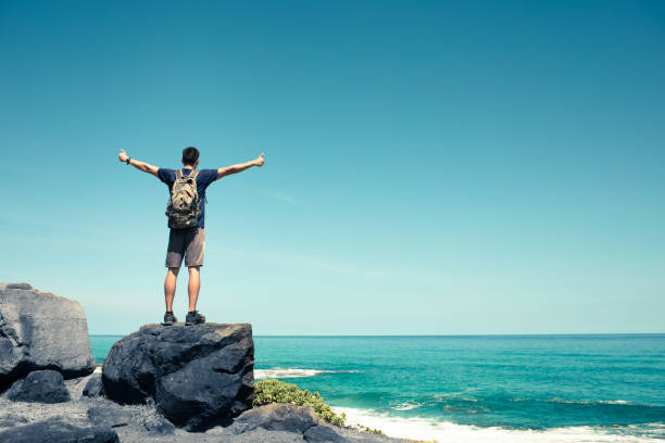 istock Feeling free. Happy young man outdoors. 1353676025
