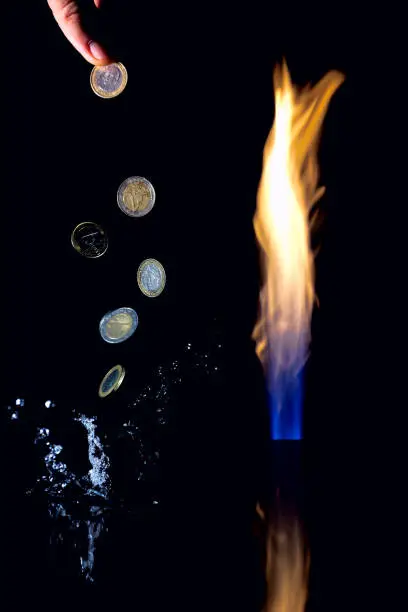 A gas flare devouring money. Gas money. Pillar of fire and levitating Euro coins. A splash of water flying around.
