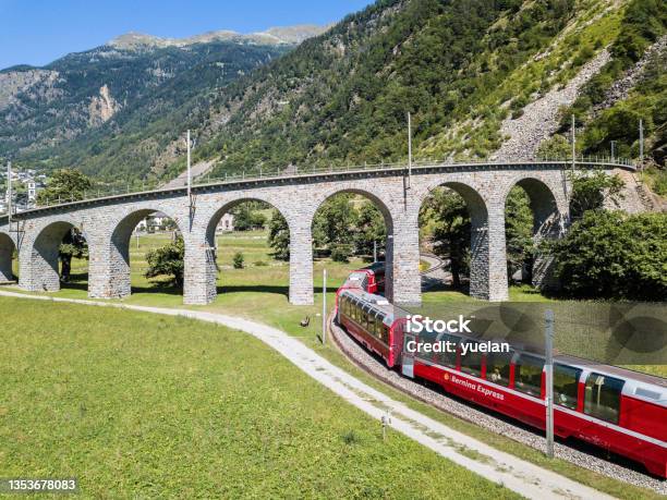 Bernina Express Is Going Through The Famous Brusio Circular Viaduct Stock Photo - Download Image Now