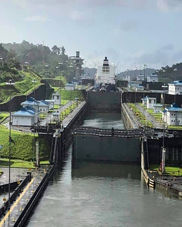 Gatun Locks, The Panama Canal is a navigation channel located between the Caribbean Sea and the Pacific Ocean.