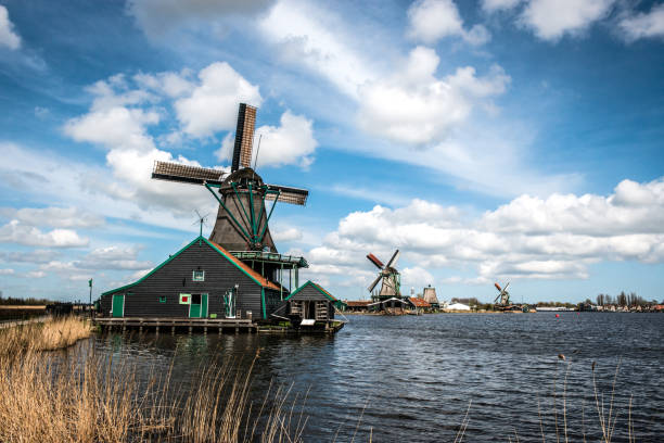 istock Beautiful Houses With Windmills, The Netherlands 1353680055