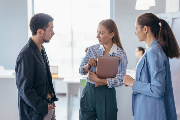 istock Employees in office talk about business topics. 1353681780