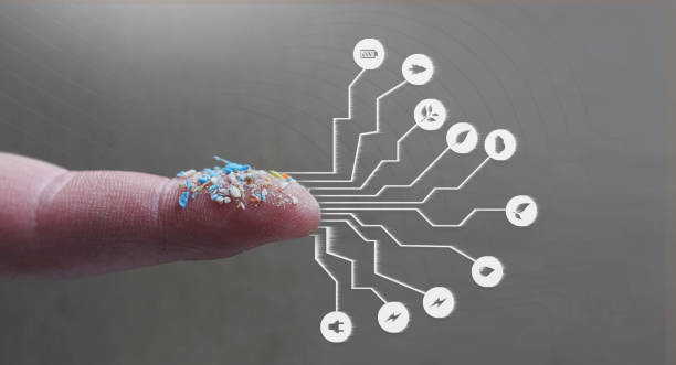 Infographic of microplastics on a human finger. Creative concept cf water pollution and global warming. stock photo