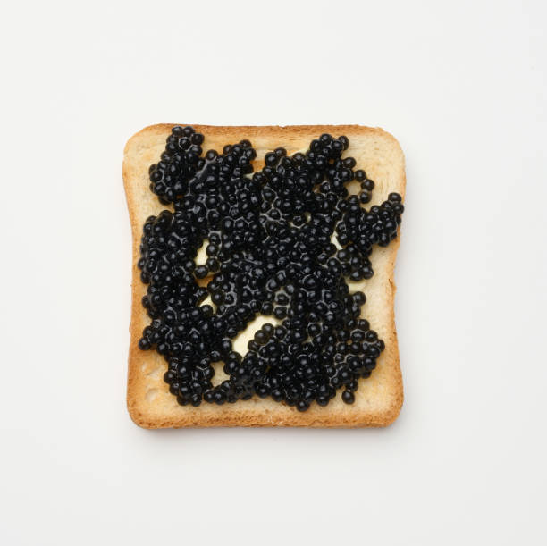 istock paddlefish caviar on a square slice of white wheat flour. Top view on white table 1353682976
