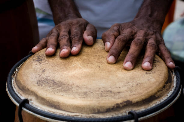 Hands of a musician playing percussion in presentation. Hands of a musician playing percussion in presentation. Salvador, Bahia, Brazil. african rhythm stock pictures, royalty-free photos & images