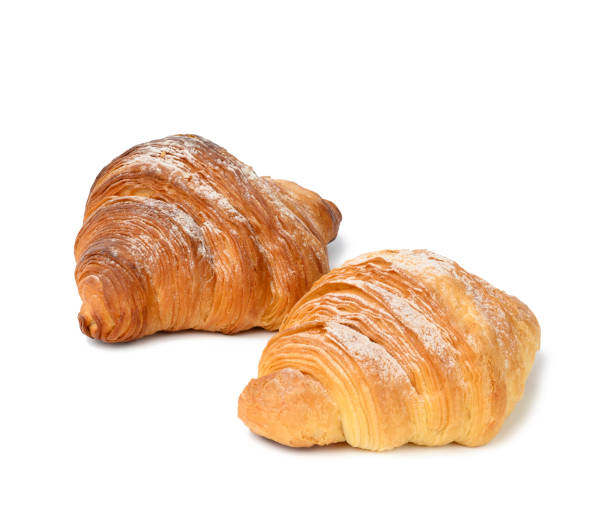 istock two baked croissants on a white isolated background, dessert for breakfast sprinkled with powdered sugar 1353687877