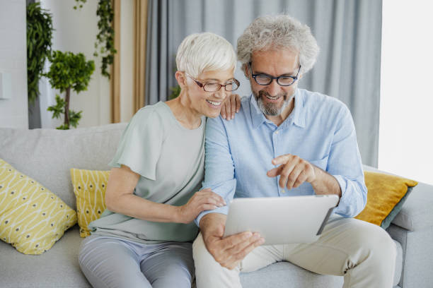 istock A mature couple uses a digital tablet at home 1353689220