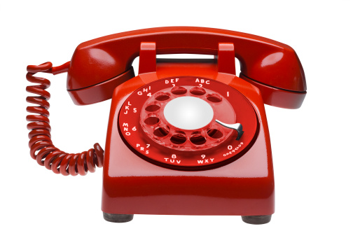 Red  60s rotary dial phone on white, isolated with clipping path