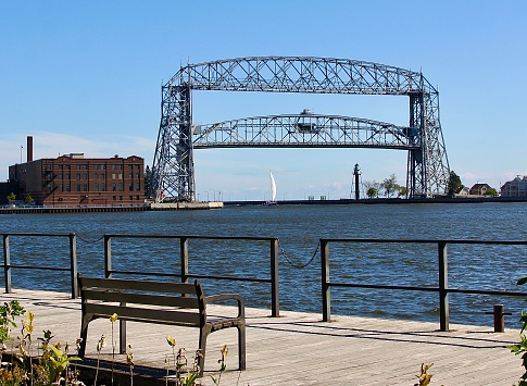 The Aerial Lift Bridge in Duluth Minnesota lifts to let a sailboat go under.