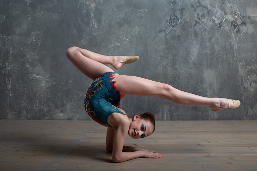 Young girl professional gymnast woman dance rhythmic gymnastics at studio.